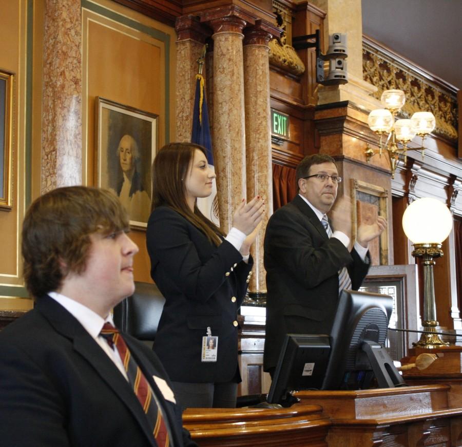 Lexi Weber 14 stands with the speaker of the house to welcome a group of visitors.