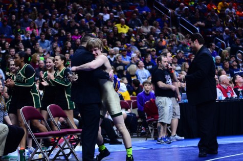 Nelson Brands `18 hugs Assistant Coach Kody Pudil after winning the 2016 3A 138 pound state title.