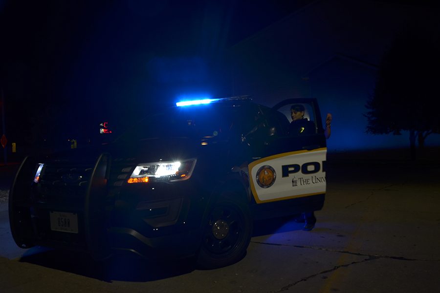 Officer Tristian enters a police vehicle.