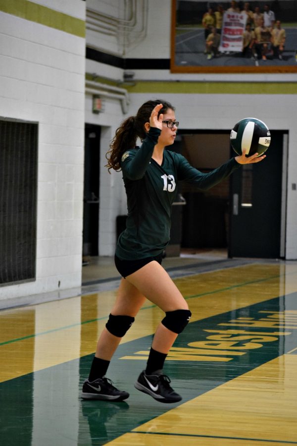 Morgan Hawkins '19 steps up to serve.