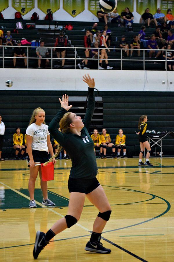 Grace Fleckenstein 19 spikes the ball.