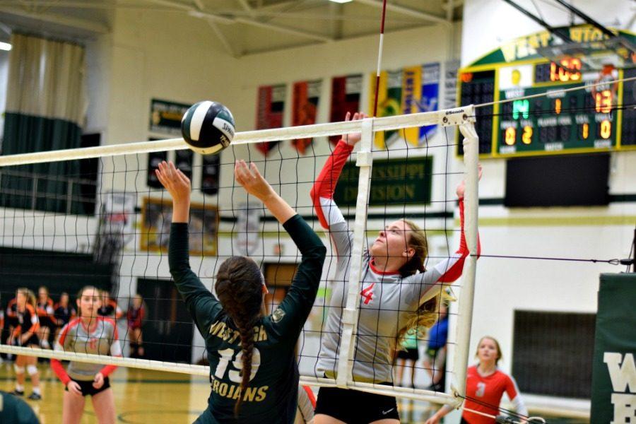 Ellie Kouba 19 sets the ball.