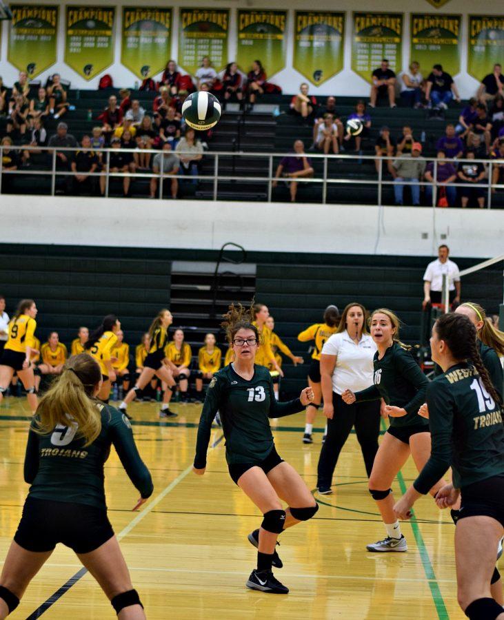 West High volleyball players coordinate their play.