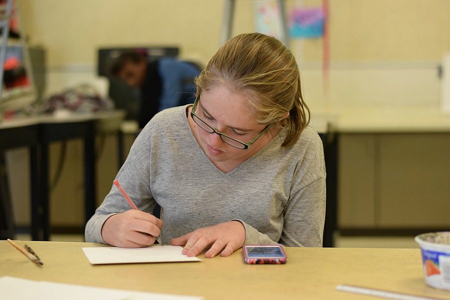 Allison Alfschuler '19 sketches her drawing prior to water coloring it.