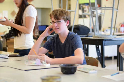 William Gleason 20 talks to his friends while sketching.