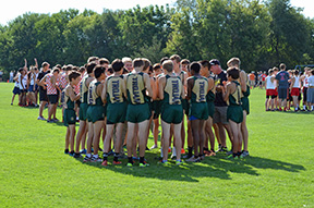 The team huddles before the start of a race.