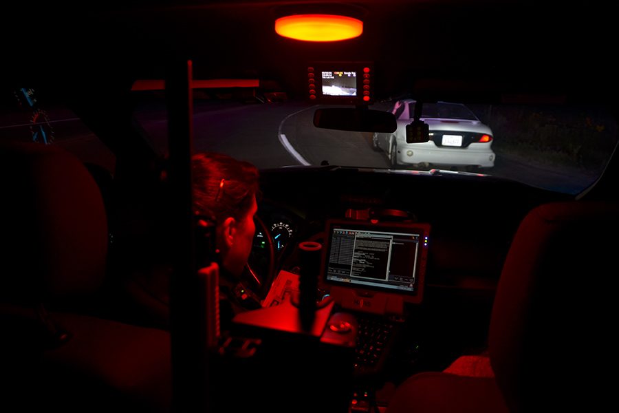 Officer Tristian electronically files a pull over under a red light to avoid the fishbowl feeling that comes from using the brighter incandescent light. 