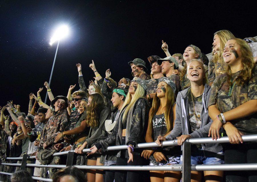 The West High student section cheer on the West football team.