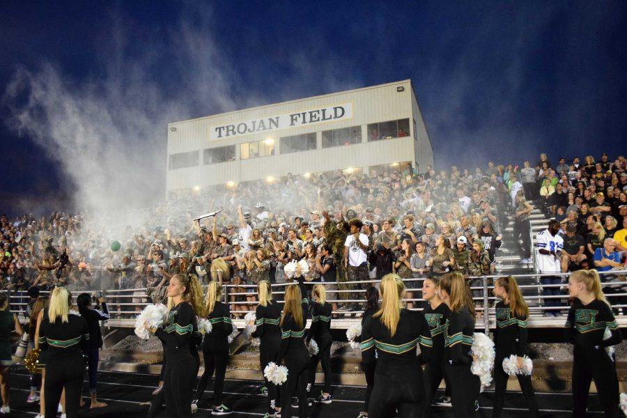 The West High student section throw white powder in the air to celebrate the Battle of the Boot.