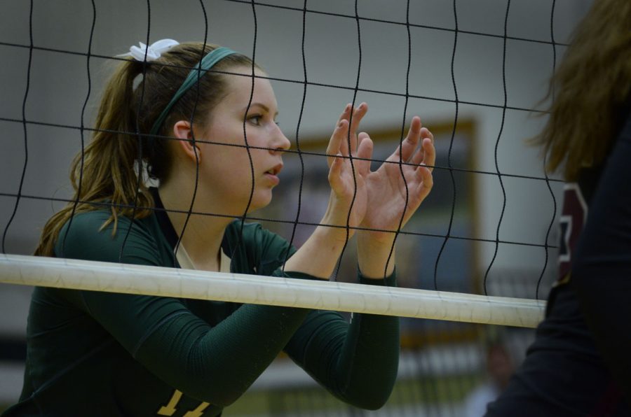 Maddie Fay `17 prepares herself at the net, waiting a Waterloo West serve.
 Photo by Leah Dusterhoft