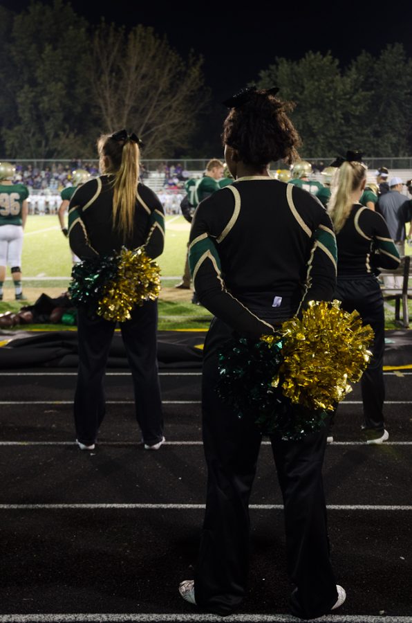 Cheerleaders face the field as the game progresses.