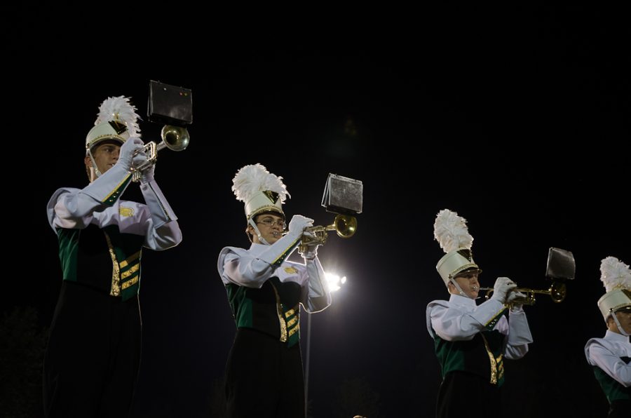 Performing at half time, the marching band takes the field. 