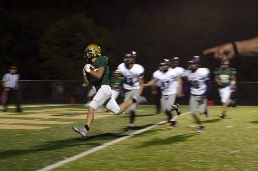 Scoring a touchdown, Brennon Keen '18 breaks through Burlington's defense.