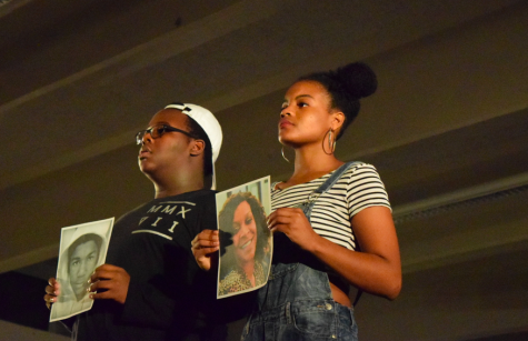 Damarius Levi '19 and Jade Merriwether '17 hold up pictures of African-Americans unjustly killed.