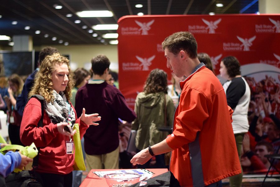 A high school students speaks to a Ball State University representative.