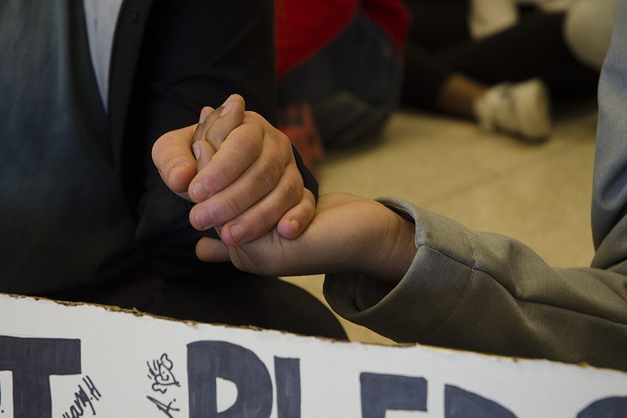 Julie Watkins '17 and Lujayn Hamad '18 hold hands during the protest.