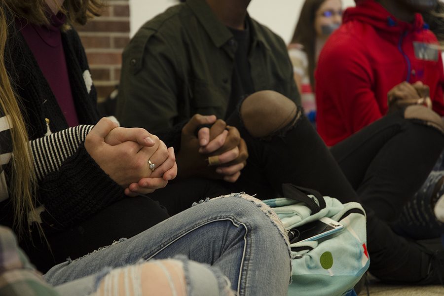 Hand in hand, protesters sit soundlessly in the commons during  