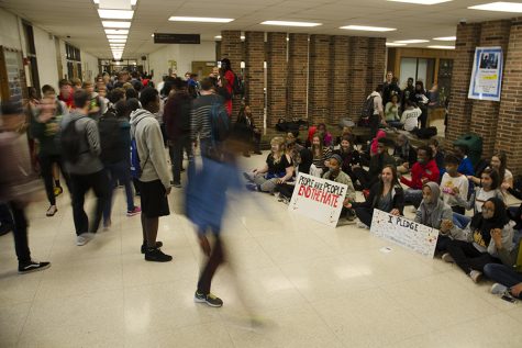 A student watches the sit-in after school in the flooded hallways.