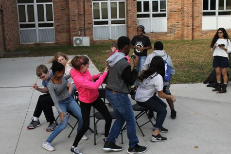 a group of West High student compete to get a seat while playing musical chairs  (Allie Schmitt-Morris) 