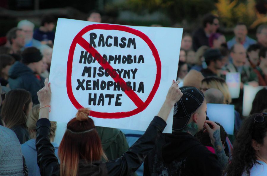 A sign displaying with crossed out words saying Racism; Homophobia; Misogyny; Xenophobia; Hate at the Penacrest Downtown Iowa City.  