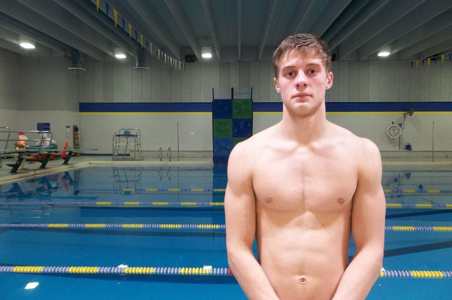 Brennon Keen 18 stands by the Coralville Recreation Center swimming pool. The No. 9 ranked Trojans faced No. 10 Cedar Rapids Washington on Tuesday, Jan. 10.