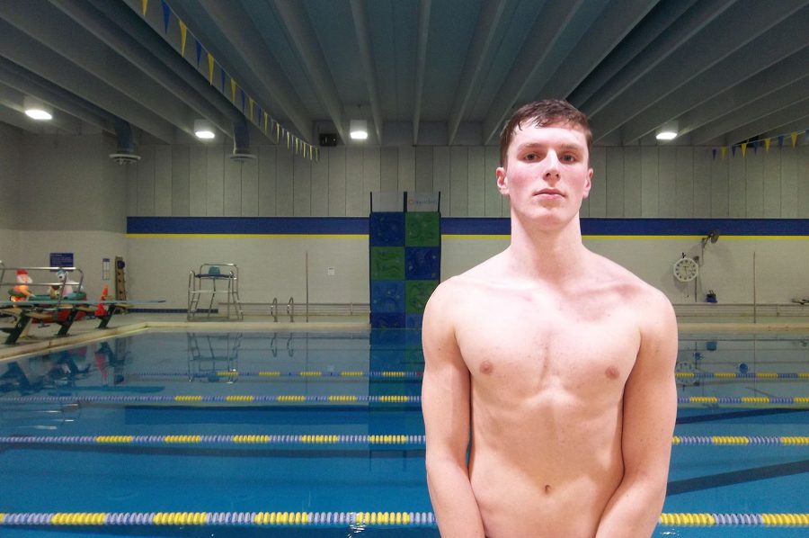 Ben Berhow 18 stands by the Coralville Recreation Center swimming pool after practice. The No. 9 ranked Trojans faced No. 10 Cedar Rapids Washington on Tuesday, Jan. 10.