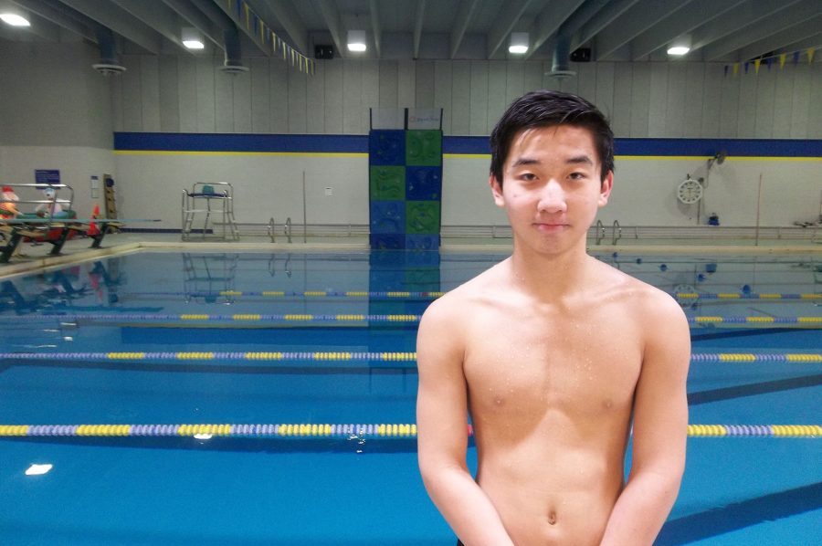 John Li 19 stands by the Coralville Recreation Center swimming pool after practice.  The No. 9 ranked Trojans faced No. 10 Cedar Rapids Washington on Tuesday, Jan. 10.