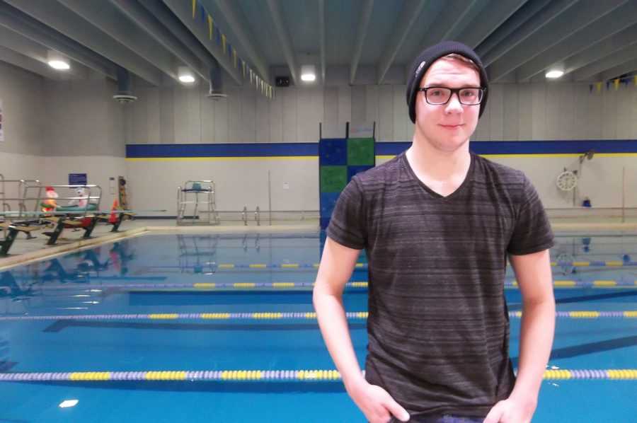 Ben Schroeder stands by the Coralville Recreation Center swimming pool after practice.  The No. 9 ranked Trojans faced No. 10 Cedar Rapids Washington on Tuesday, Jan. 10.