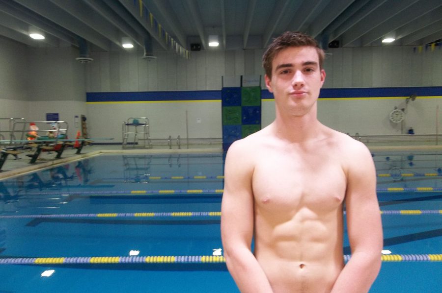 Ethan McAreavy 18 stands by the Coralville Recreation Center swimming pool. The No. 9 ranked Trojans faced No. 10 Cedar Rapids Washington on Tuesday, Jan. 10.