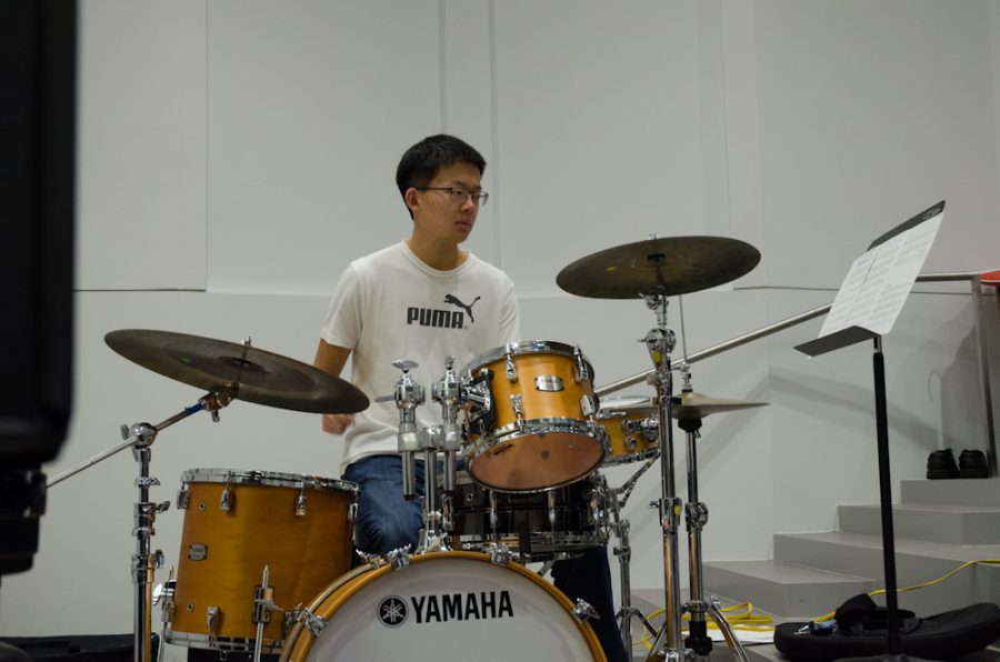 Keeping the swing of things, Sean Chi '19 drums in the Jazz Band just before noon. 