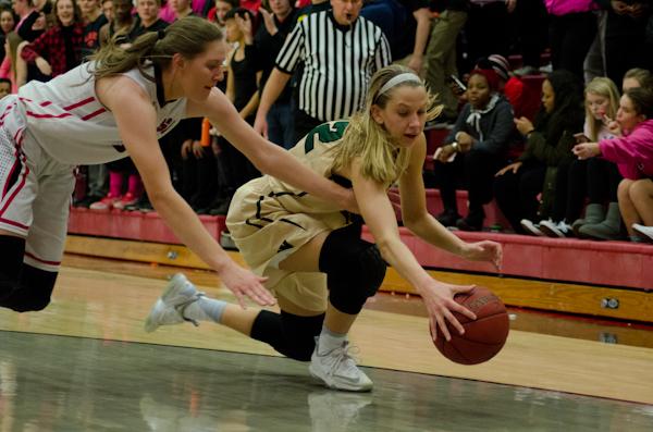 On the offensive, Logan Cook '18 dives for the ball with the Little Hawk's Ashley Joenes '18 at her feet. 