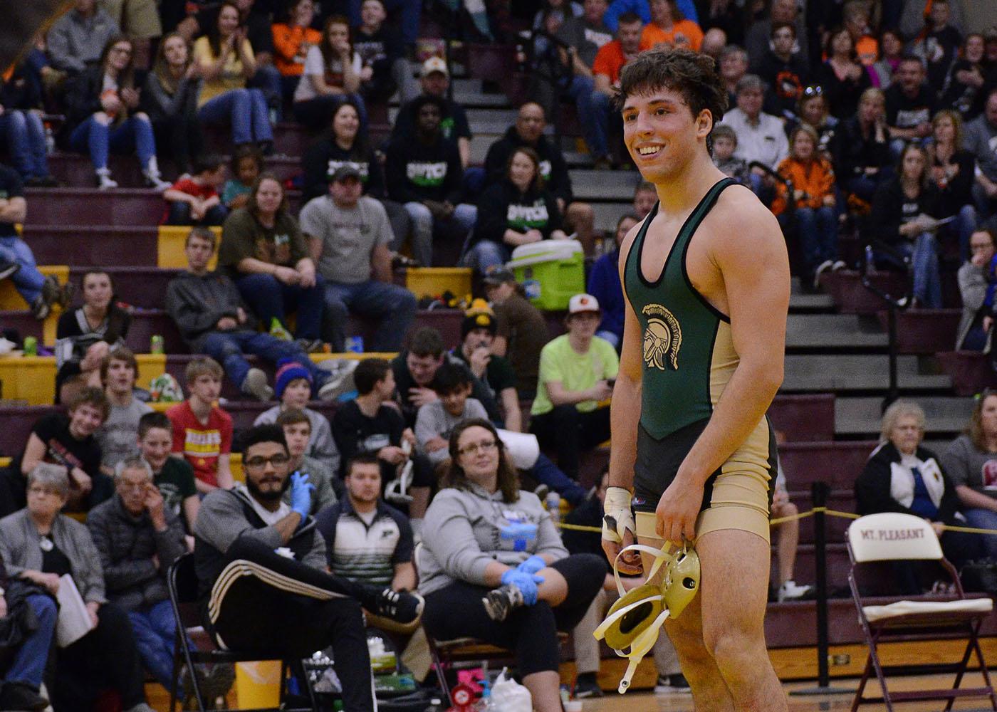 Alex Aguirre '17 smiles at head coach Mark Reiland after winning the District 5 tournament to punch his ticket to the Iowa High School State Wrestling Championships. (Feb. 11, 2017)