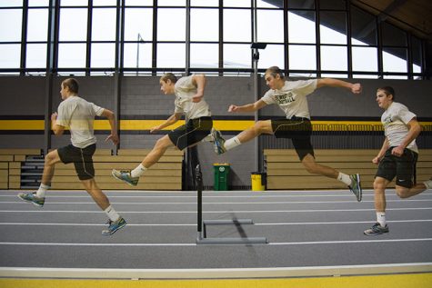 Cole Mabry 19 practicing at University of Iowas indoor track facility with his trainer Ethan Holmes. He goes through hurdle drills and speed work during practice.