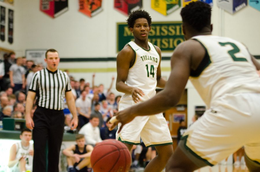 In the second half, Hakeem Odunsi '18 makes a pass to teammate Devontae Lane'17.