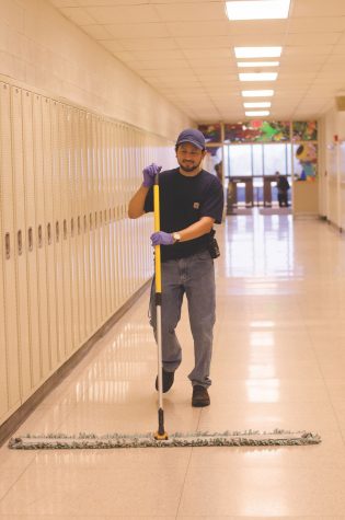 Carlos mopping the art hallway. Photo by Sarah Longmire