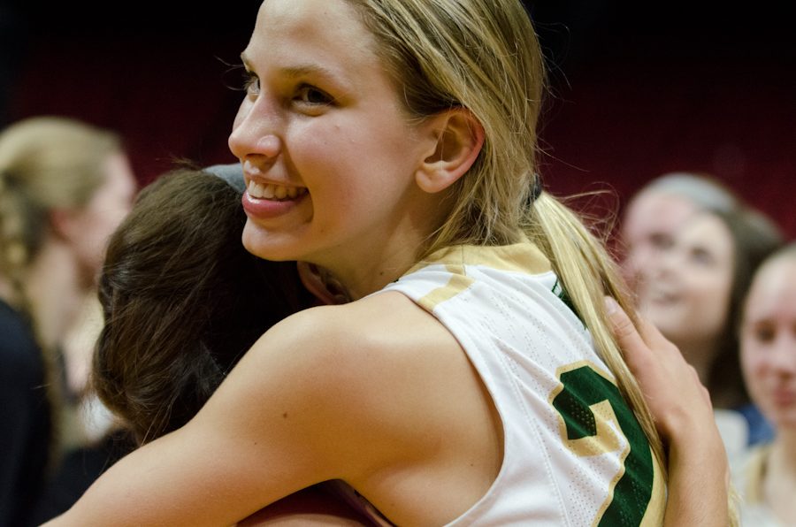 Logan Cook '18 hugs Cailyn Morgan '19 after winning their game against Waukee in the girl's state quarter finals 40-38.