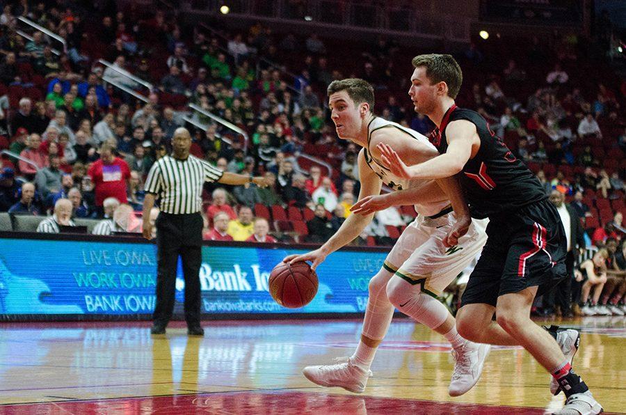 Connor McCaffery '17 works his way past Newton's defense in the second half of the 4a state quarterfinal game at Wells Fargo Arena. McCaffery will end up scoring eighteen points for the Trojans by the end of the game.  