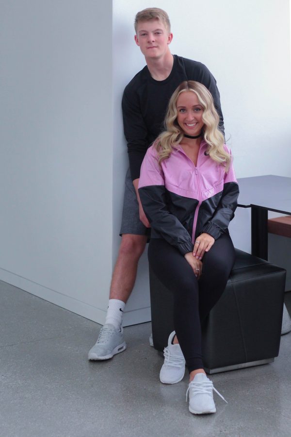 Natalie Roetlin 18 and Evan Flitz 18 pose together at theVoxman Music Building in their sporty outfit. 