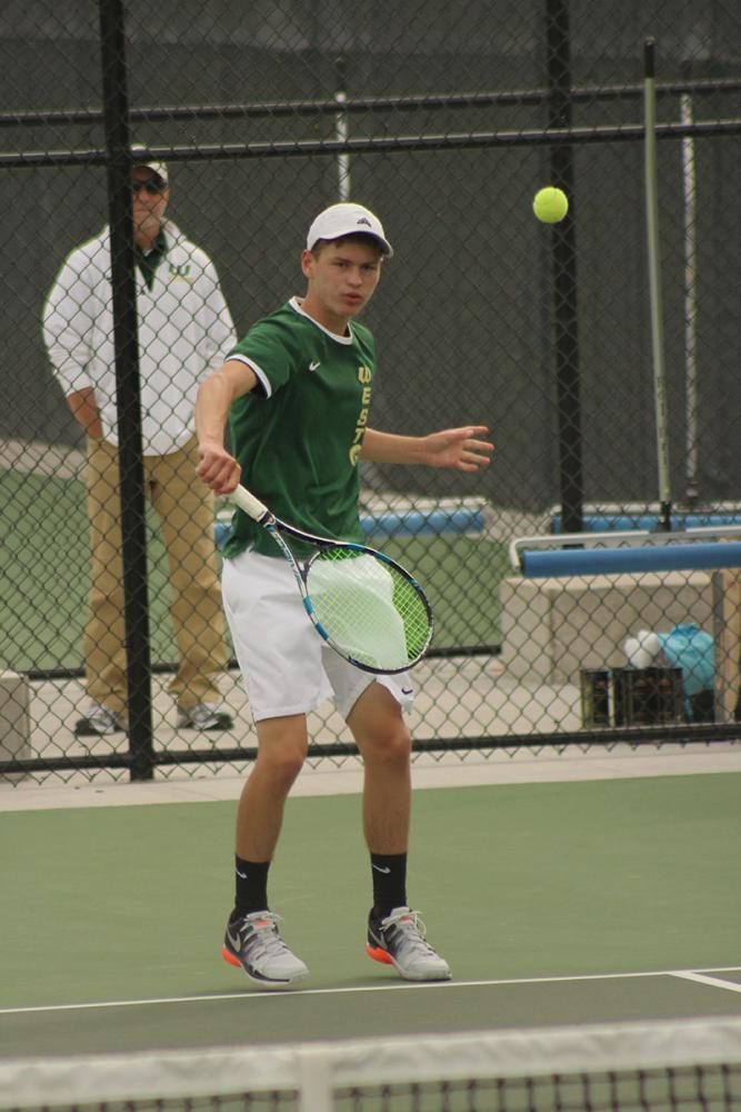 Senior Cole Schneider hits the tennis ball back to a player from Linn-Mar. 