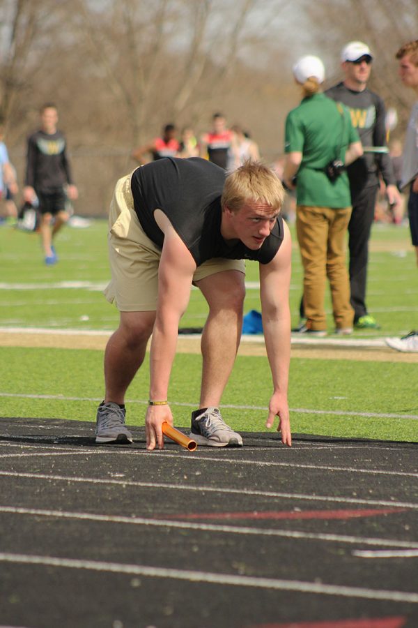 Thomas Adolph '18 gets ready for the start of the thrower's 4x100 meter race.