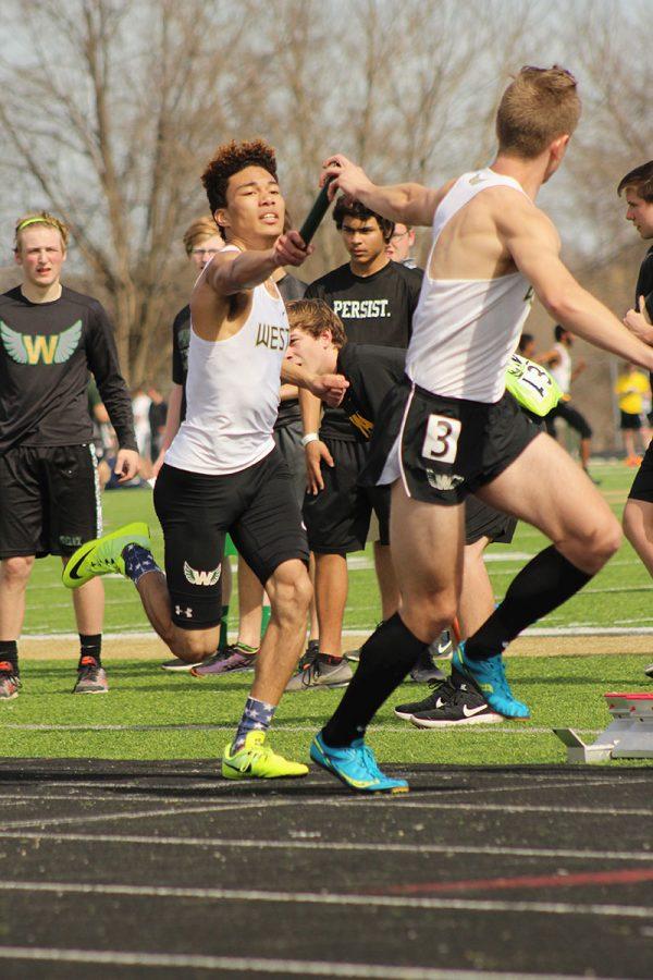 Gabe Caruthers '19 passes the baton to the anchor Nate Jelinek '17 in the 4x400 meter relay. 