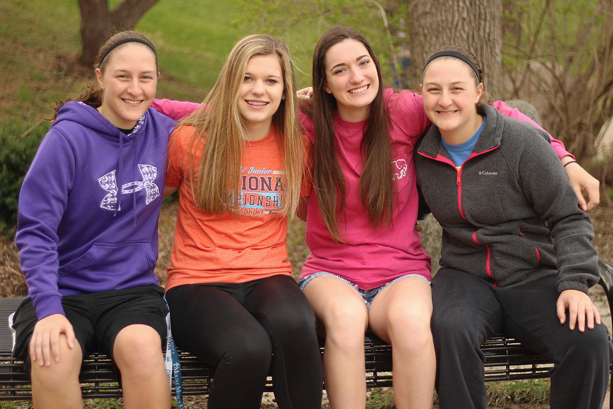 Allison Bys '17, Rylee Fay '20, Ellie Kouba '19 and Ashley Bys '17 smile together on a bench before school on Friday April 14th.