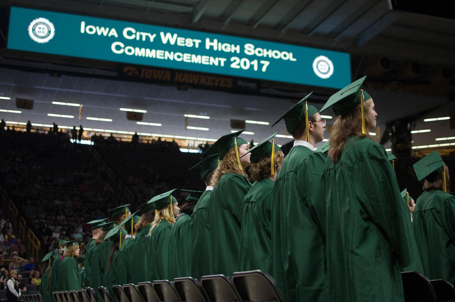 After the Processional to their seats on the floor of Carver-Hawkeye Arena, the West High School graduating class of 2017 waits for the Alma Mater to begin on May 27. 