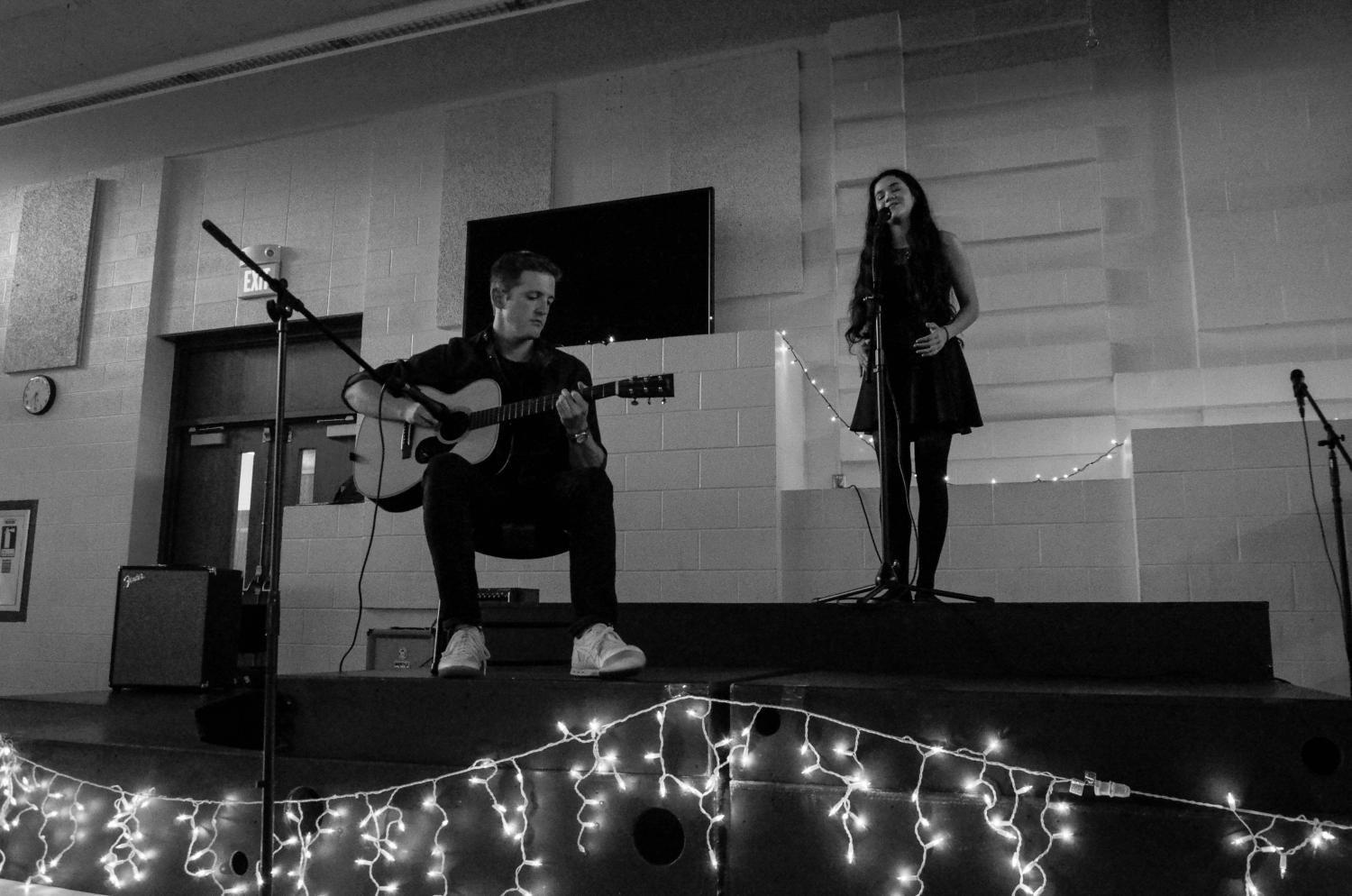 Social studies teacher Dominic Iannone performs Like a Star by Corinne Bailey Rae with Olivia Manaligod 18 for the fundraising Music Playathon held on May 20 in the West High Cafeteria.  
