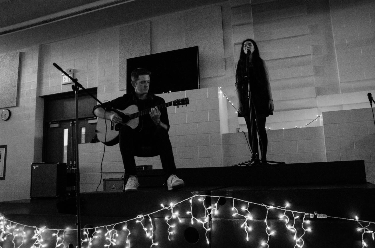 Social studies teacher Dominic Iannone performs Like a Star by Corinne Bailey Rae with Olivia Manaligod 18 for the fundraising Music Playathon held on May 20 in the West High Cafeteria.  
