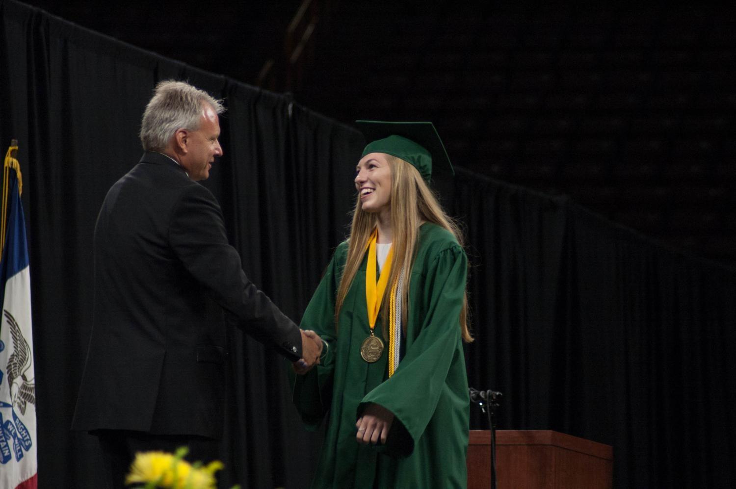 Vice Class President Ali Tauchen shakes hands with Principal Dr. Gregg Shoultz before receiving her diploma at Carver-Hawkeye Arena on May 27. 