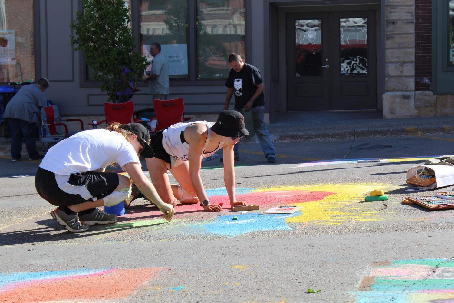 Two artists work together on their chalk piece. As artists worked, people could vote for their favorite piece that they wanted to receive the People’s Choice award. 