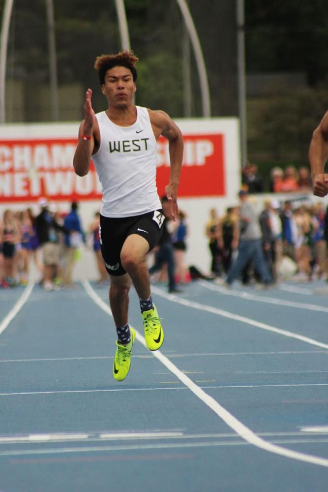 Gabe Caruthers '19 sprints during the 200 meter dash prelims. He ran a time of 22.36, where he missed getting into the finals by .13 seconds. 