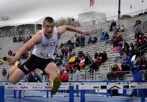 Cole Mabry 19 runs over a hurdle during boys shuttle hurdle relay on Saturday, May 29 at the Drake Relays. The West High boys placed ninth in the event.