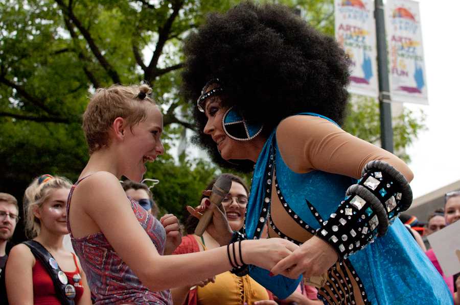 Candi Stratton, as Cher, smiles at a young girl after giving her a kiss during her performance in the Iowa City Pedestrian Mall on June 17.